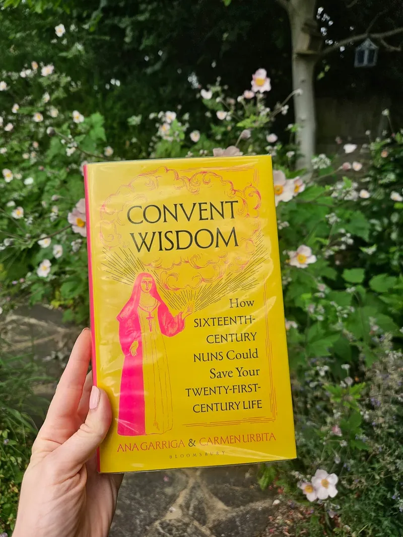 Julia holding a copy of Convent Wisdom