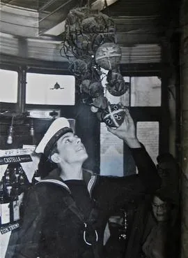 Sailor placing the bun on Good Friday in 1958.